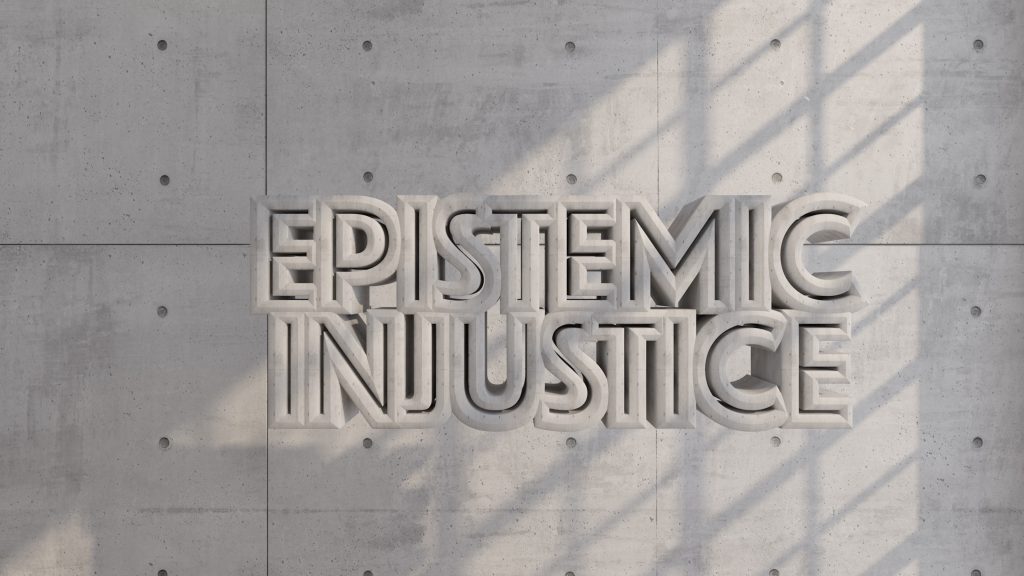 A CGI image of the words “EPISTEMIC INJUSTICE” rendered in concrete text, floating in the air with a concrete wall behind, light streams through through a window from the right out of shot